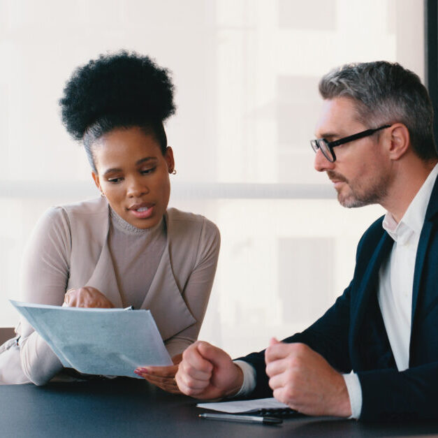 Document, advice and business people with budget, research and talk for financial discussion. Accountant, woman and mature professional with papers, company revenue or bookkeeping report for audit