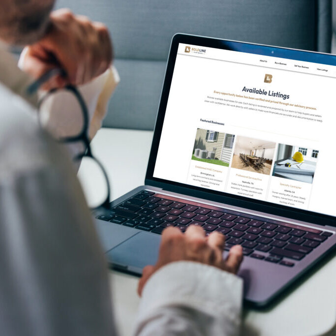 A professional focuses on analyzing detailed business reports displayed on a laptop screen. The graphics include various charts and performance metrics, highlighting statistical trends for comprehensive decision-making in a corporate environment.